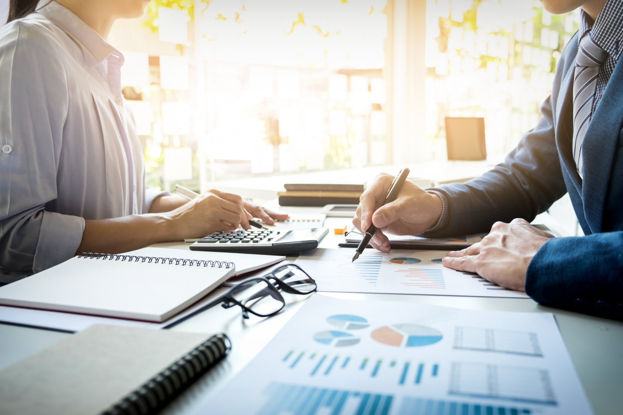 Payroll specialist reviewing salary calculations and statutory reports